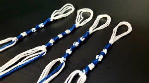 White and blue tzitzits on a black background