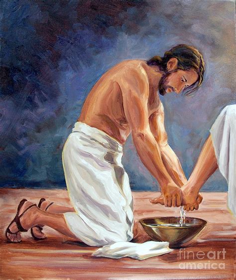 A man on his knees washing another man's feet.